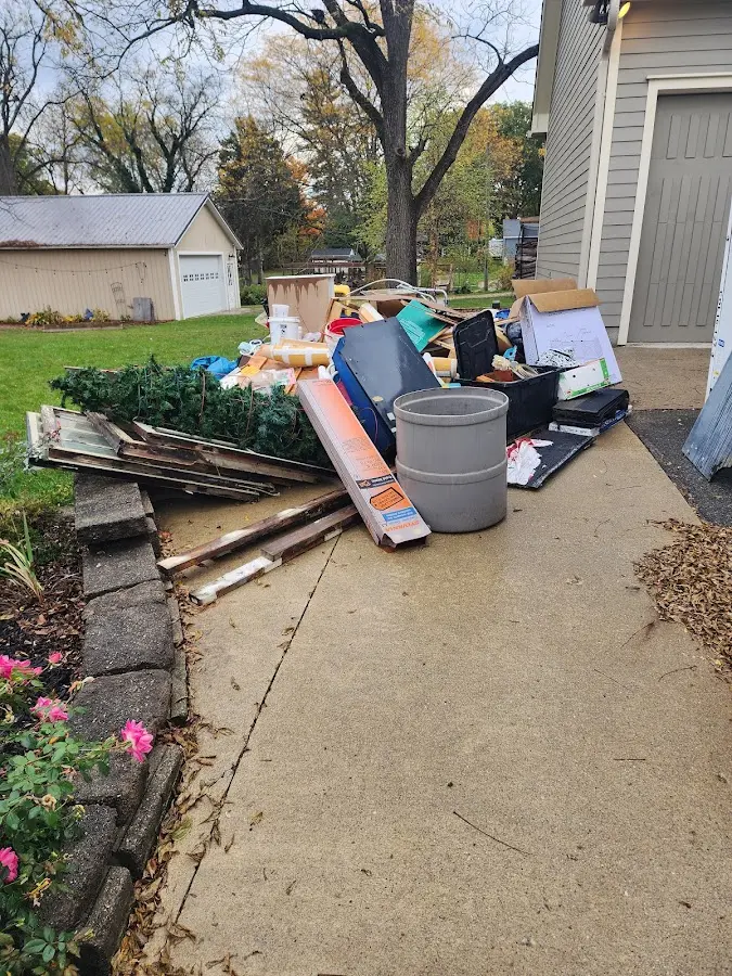 Dumpster being loaded with debris for 12 Yard Dumpster Rental in Waterloo